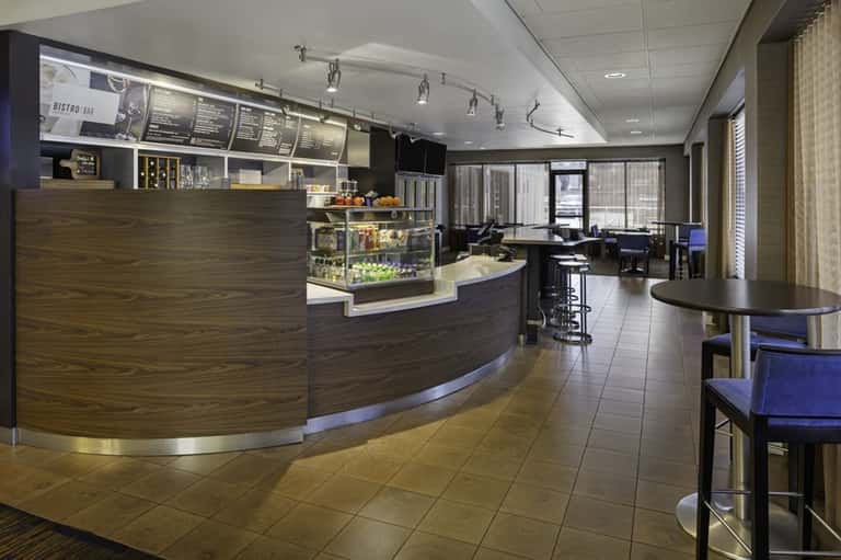 Modern cafe bistro interior with curved counter, menu boards, and seating area