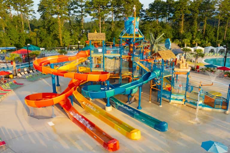 Waterpark with colorful slides, splash pad, play structures, and pools
