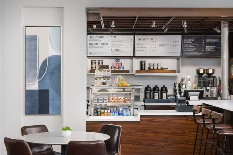 Modern hotel café with coffee bar and menu boards