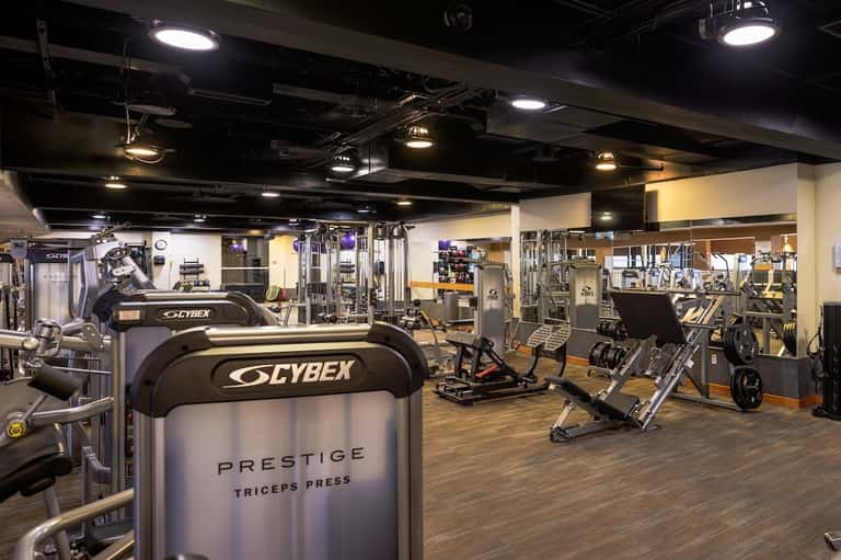 Spacious fitness center with Cybex equipment and mirrors throughout