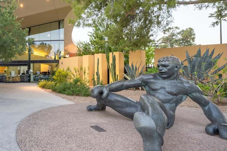 Modern desert home exterior with contemporary architecture, sculpture, and desert landscaping