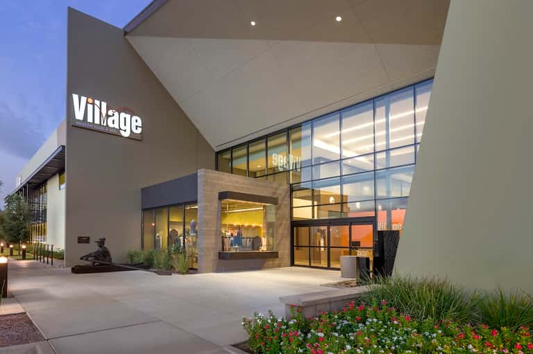 Contemporary Village shopping center entrance with modern architecture and landscaping