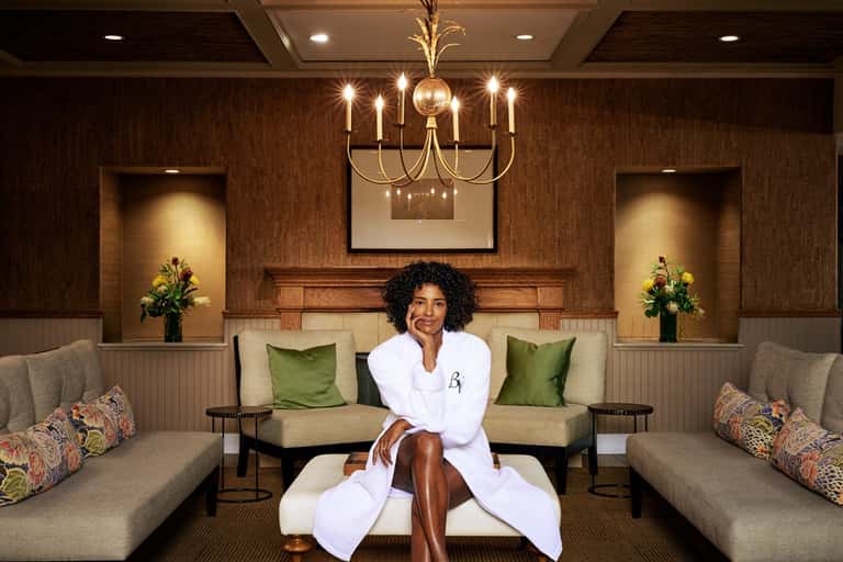 Spa relaxation room with symmetrical seating, warm lighting, and professional aesthetic
