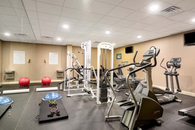 Full-service fitness center with cardio equipment, weight machines, and exercise balls