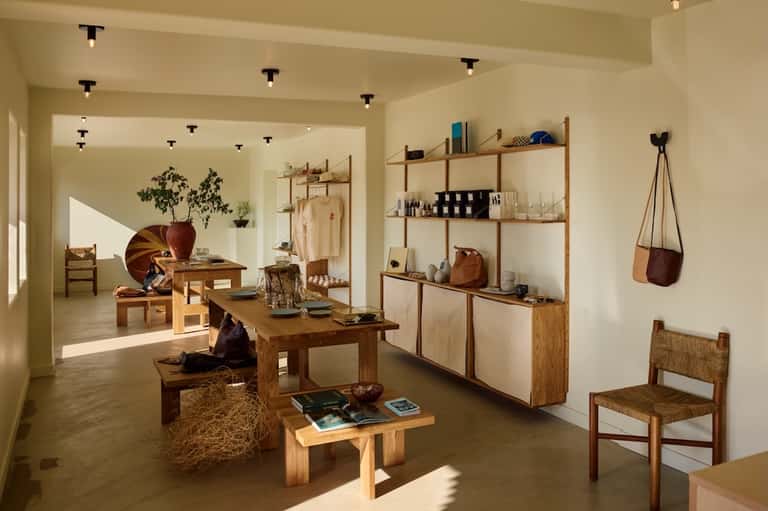 Modern wellness retail boutique with wooden shelving, natural light, and minimalist design