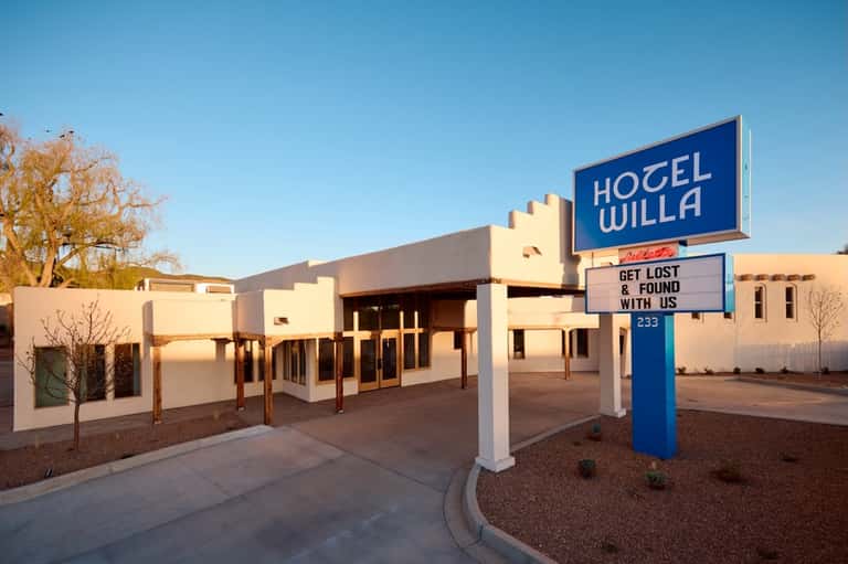 Hotel Willa vintage motel sign with cream and blue colors in desert landscape at sunset