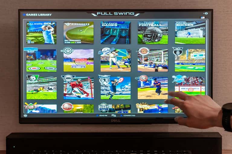 Interactive sports game console display showing Full Swing golf and multi-sport entertainment options