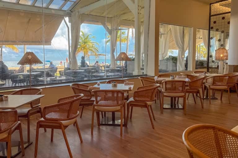Upscale restaurant interior with ocean views, modern furnishings, and contemporary design