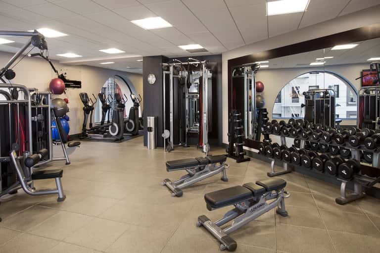 Well-equipped fitness center with cardio machines, weight racks, and strength training equipment