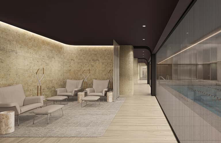 Luxury spa relaxation room with ambient lighting, beige seating, stone accents, and pool view