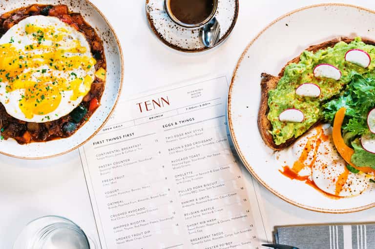 Brunch menu at TENN restaurant with eggs and avocado toast dishes displayed