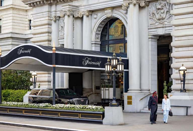 Fairmont hotel entrance with classical architecture and black awning