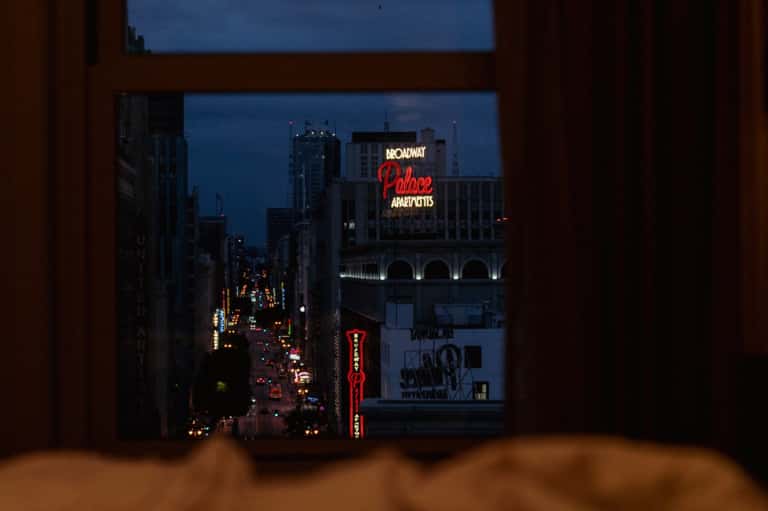 View from hotel window of Broadway street at night with illuminated theater signs