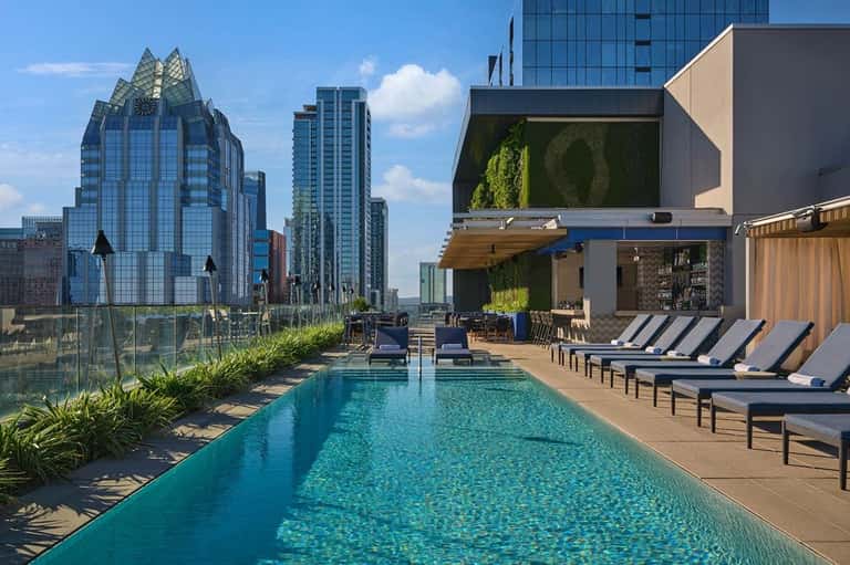 Rooftop infinity pool with city skyline views and modern architecture