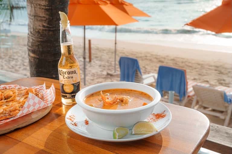 Corona beer and seafood soup at beachside restaurant with ocean view