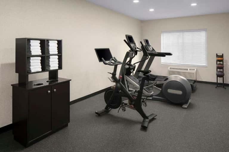 Fitness center with stationary bikes, elliptical machine, and exercise equipment