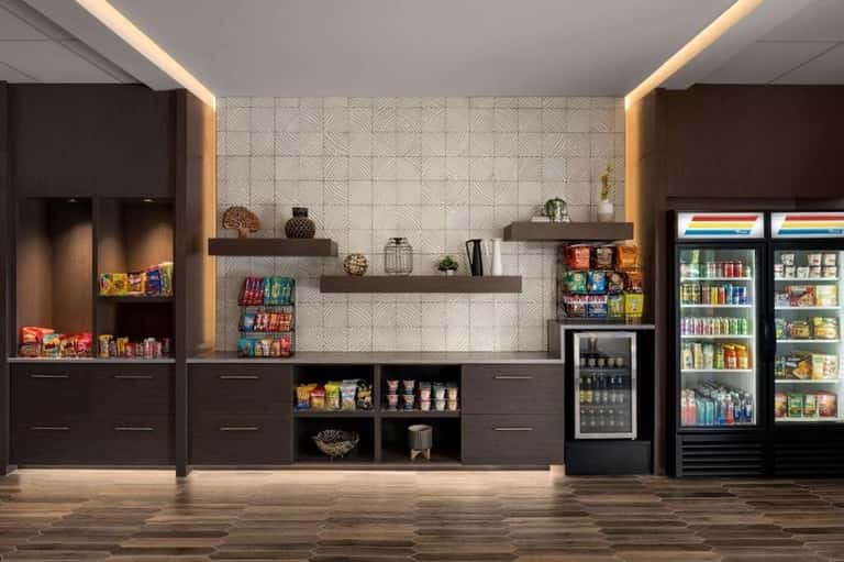 Hotel lobby convenience store with beverage coolers and snack shelving