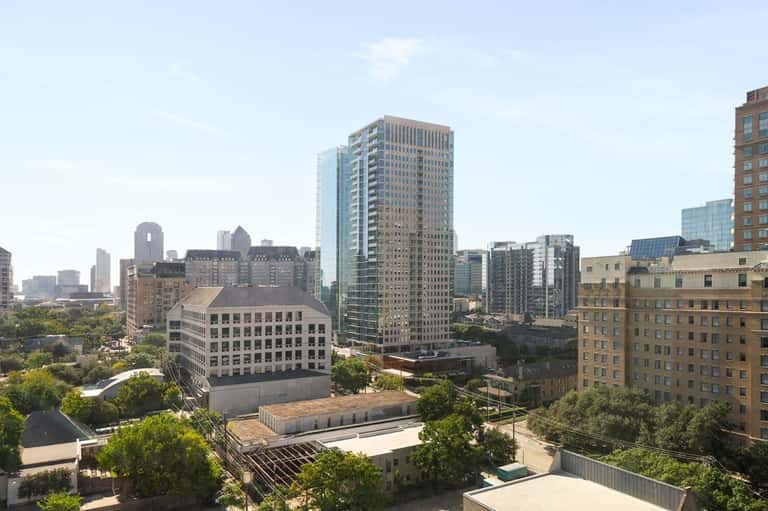 Urban downtown skyline view from high-rise residential tower overlooking city buildings