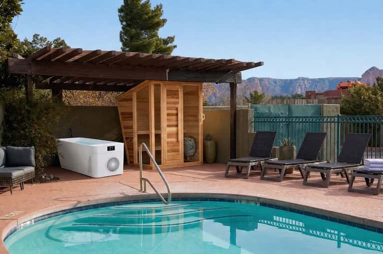 Resort poolside with sauna, lounge chairs, pergola, mountains views, and pool equipment