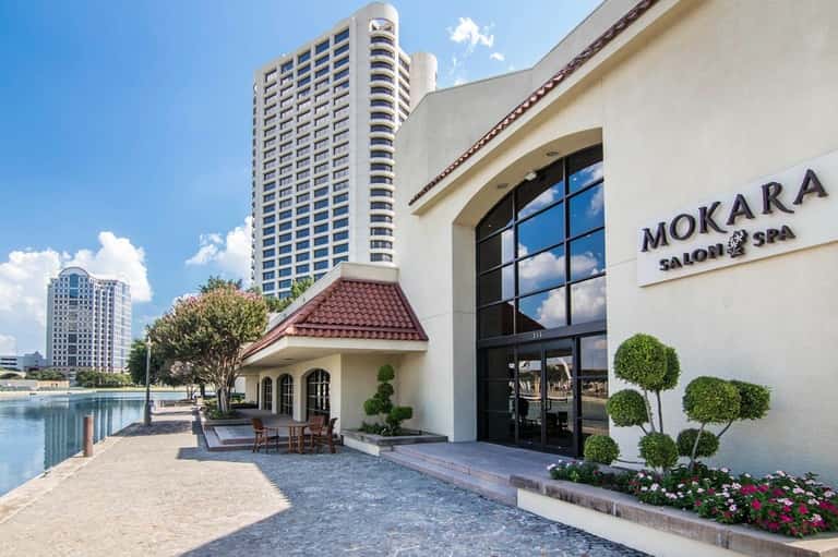 Mokara Salon & Spa entrance with waterfront building and manicured landscaping