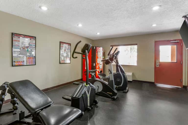 Hotel fitness center with exercise bikes, weight bench, and workout equipment