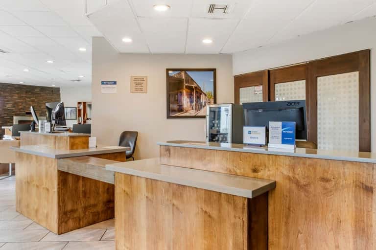 Hotel front desk reception area with wooden counter and check-in station