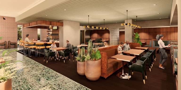 Modern hotel lobby and dining area with warm wood accents, bar seating, pendant lighting, and potted plants throughout the space