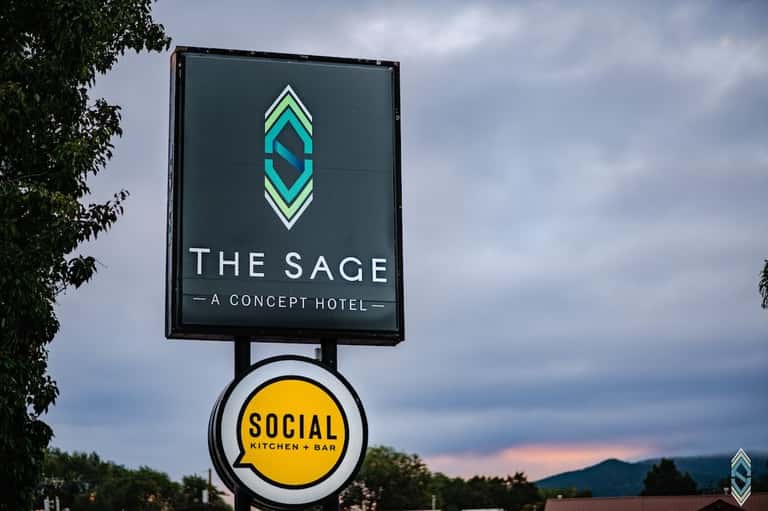 The Sage concept hotel and Social Kitchen + Bar signage with mountain landscape at dusk