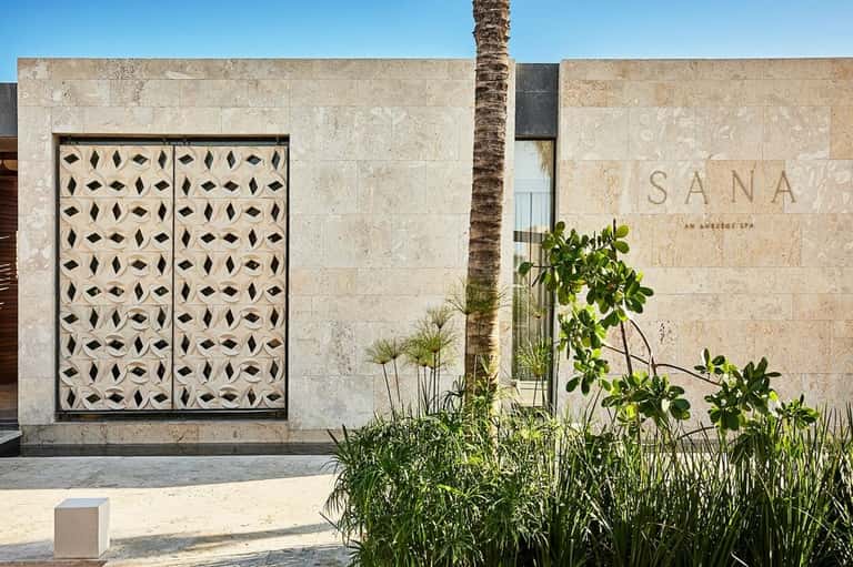 SANA boutique spa entrance with geometric patterned doors and desert landscaping in neutral tones