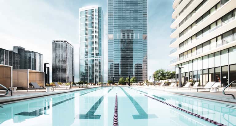 Rooftop swimming pool with lane markings, surrounding skyscrapers, and contemporary lounge areas.