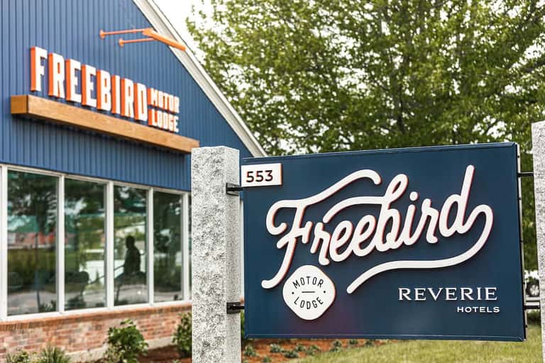 Freebird Motor Lodge Reverie Hotels exterior signage on blue building facade
