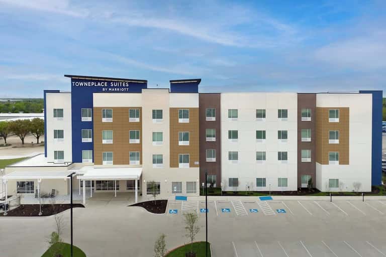 TownePlace Suites by Marriott exterior with multi-story modern building, parking lot, and landscaping
