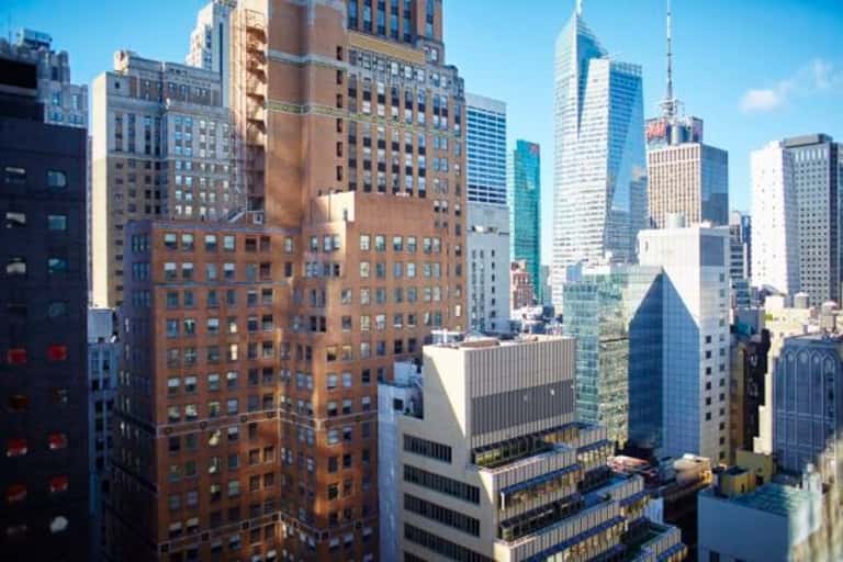 Daytime cityscape showing downtown skyscrapers and high-rise buildings under clear blue sky