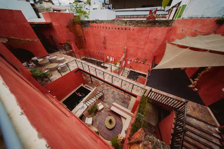 Aerial view of multi-level red courtyard with seating areas and connected pathways
