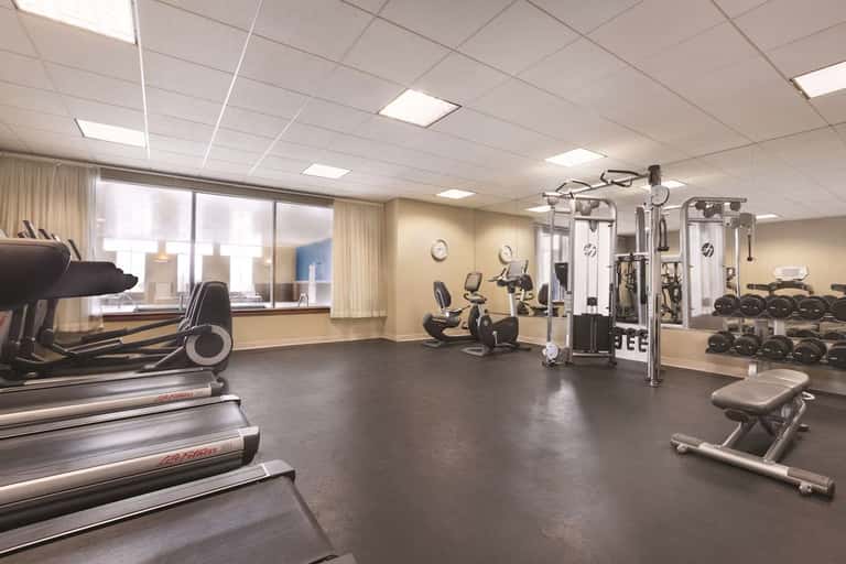 Hotel fitness center with treadmills, exercise bikes, and weight training equipment