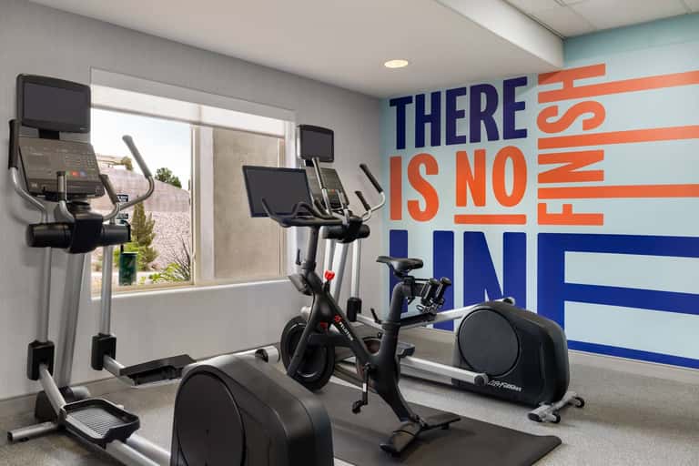 Fitness center with stationary bikes and cardio equipment, motivational wall signage