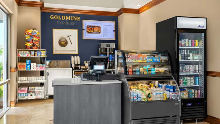 Goldmine Express convenience store interior with snack displays, refrigerated beverages and counter