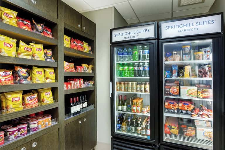 Hotel convenience shop displaying snacks, beverages, and frozen foods with Springhill Suites branding