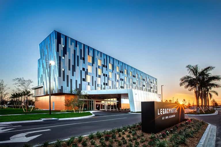 Contemporary hotel building at sunset with modern architecture and manicured grounds