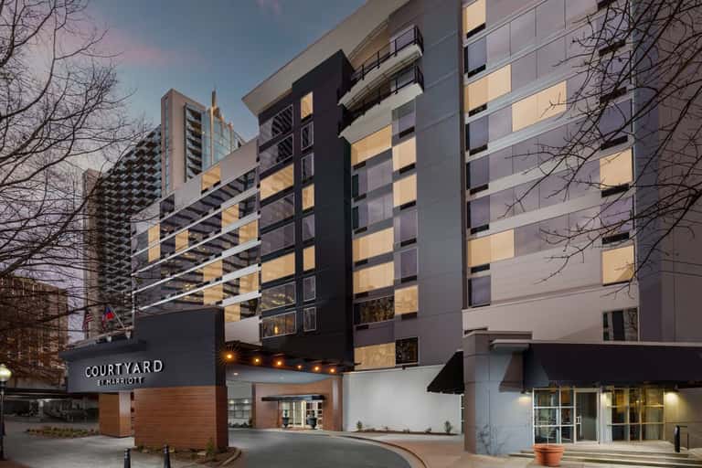 Contemporary Courtyard by Marriott exterior at dusk with illuminated windows and entrance