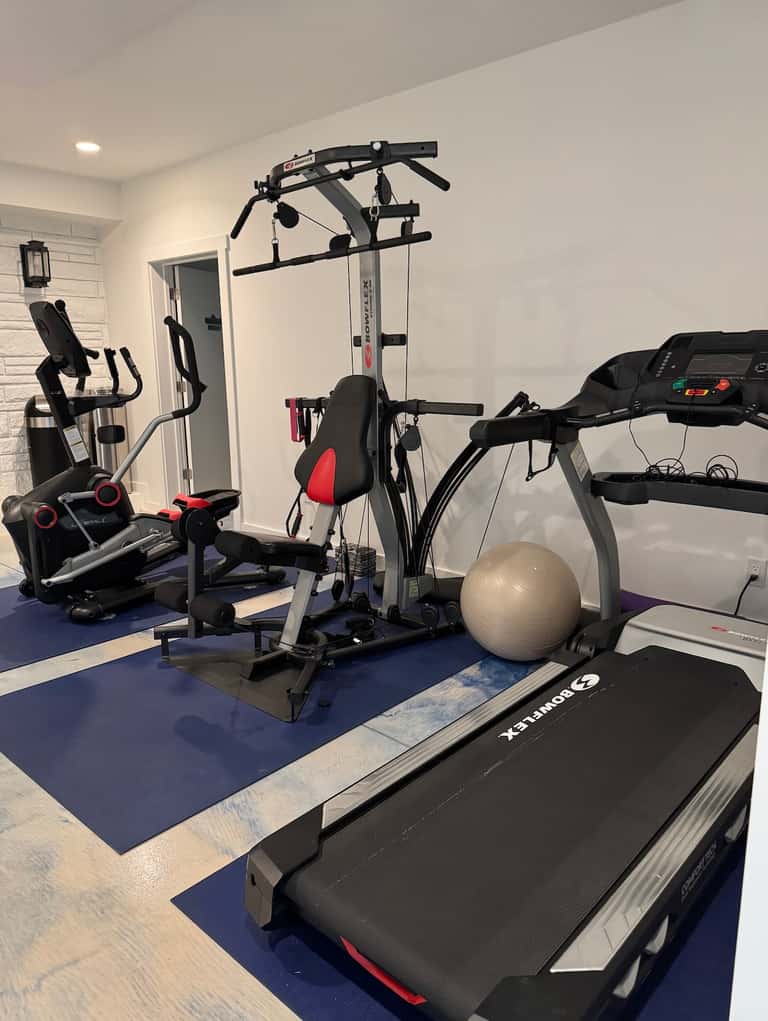 Fitness center with treadmill, exercise bike, cable machine, and stability ball