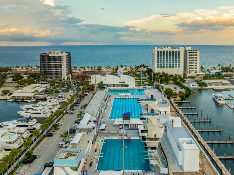 Overhead view of resort complex with Olympic pools, marina, and beachfront location