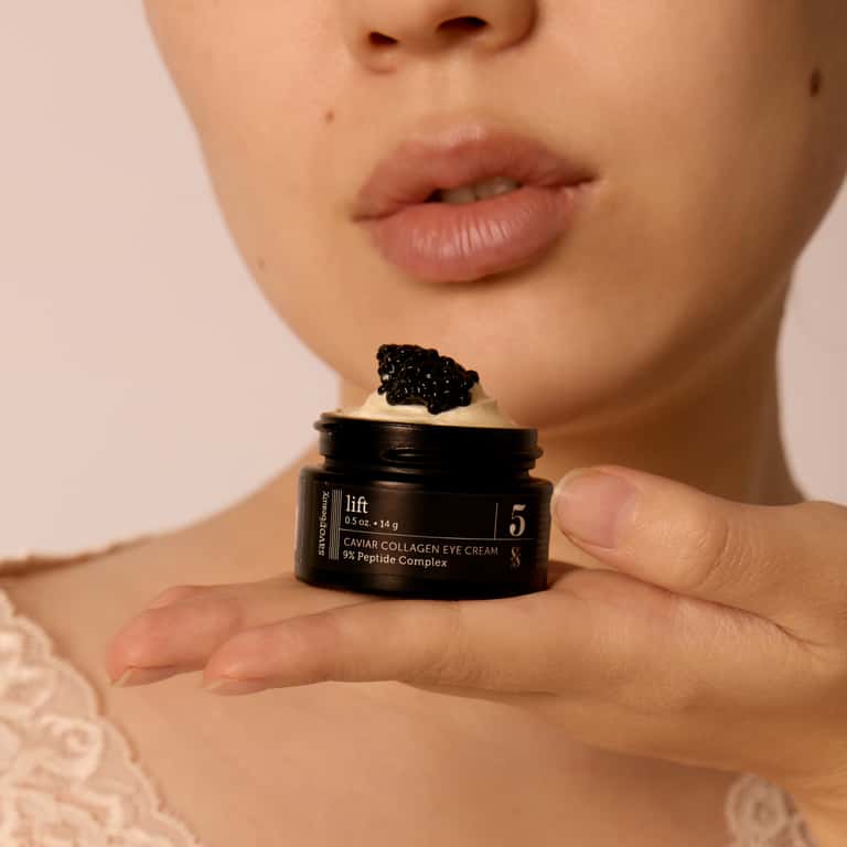 Caviar Collagen Eye Cream with 9% Peptide Complex held in hand showing texture