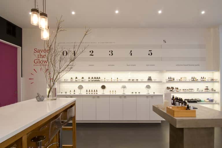 Modern Savor Beauty retail storefront with illuminated shelving and numbered product categories