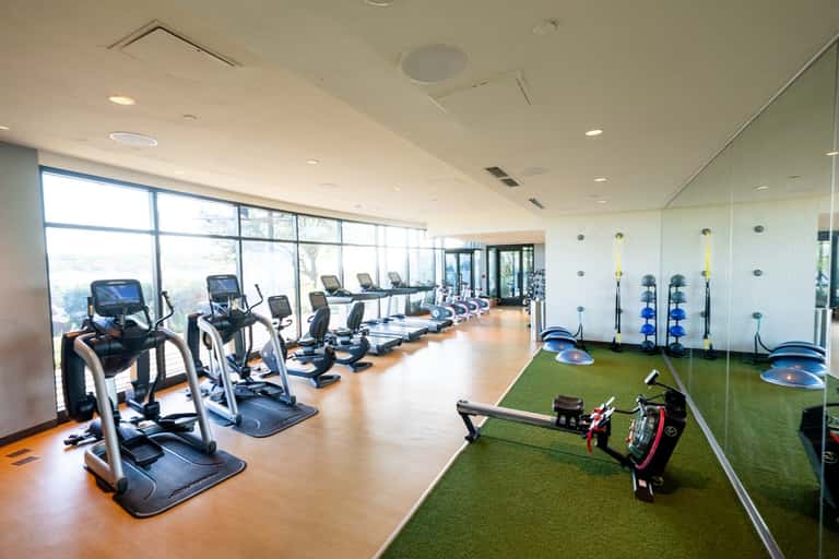State-of-the-art fitness center with cardio equipment and panoramic windows with scenic views