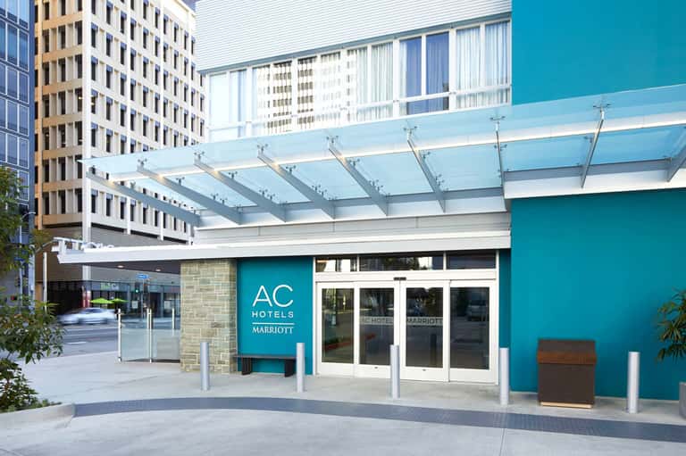 AC Hotels by Marriott turquoise entrance with glass canopy and modern architecture