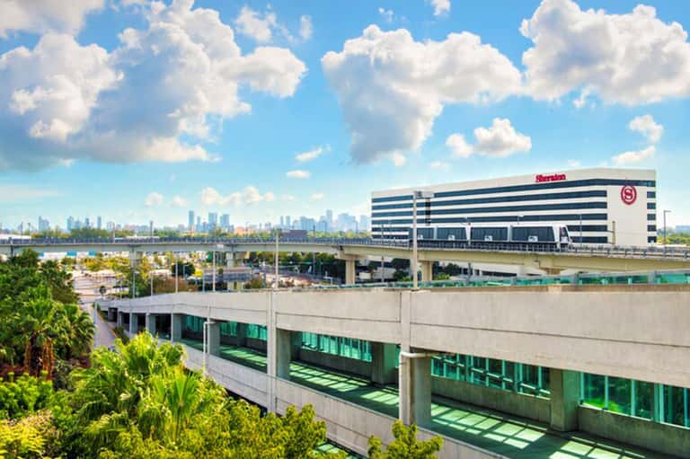 Sheraton Hotel exterior view showcasing modern architecture with city skyline visible in the background