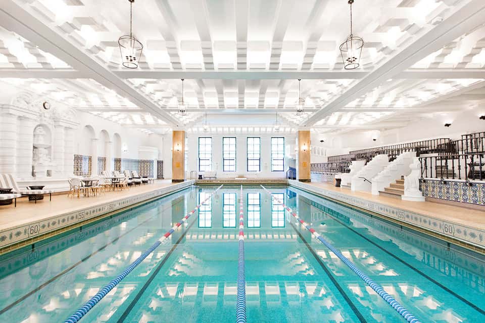 Indoor lap pool in bright, classical-style facility with natural lighting