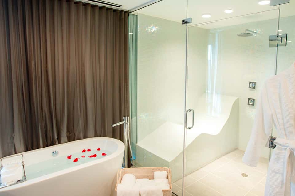 Luxurious bathroom with freestanding tub, walk-in shower, and white towels