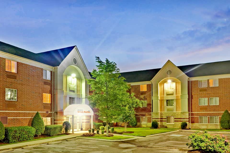 Extended Stay hotel exterior at dusk with illuminated entrance and brick architecture